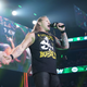AEW World Heavyweight Champion Chris Jericho gloats after laying out Cody Rhodes, who can be seen on the big screen being tended to by referee Aubrey Edwards.